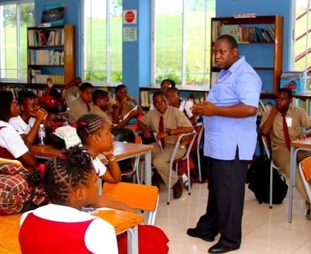 A teacher leading a class of Glenmuir students in the library